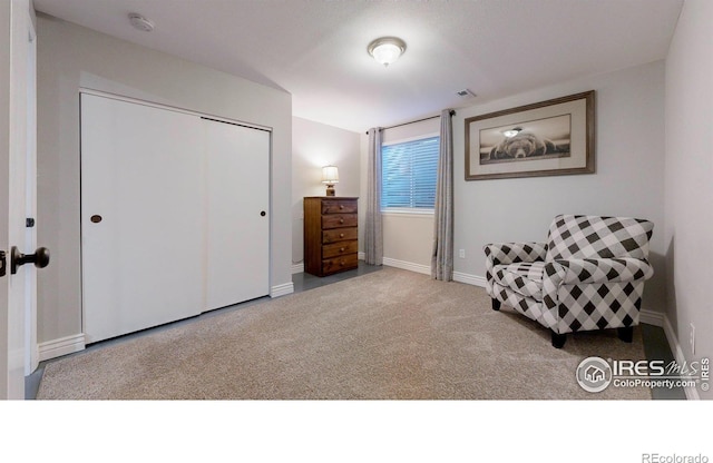 sitting room with carpet flooring, baseboards, and visible vents