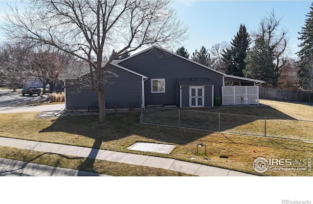 view of front of house with a front yard and fence