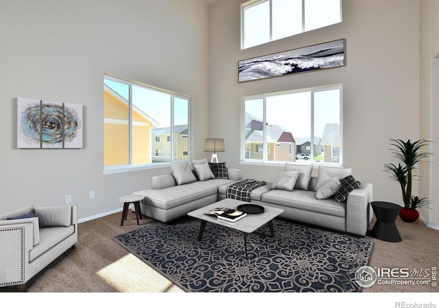 carpeted living area with baseboards and a towering ceiling