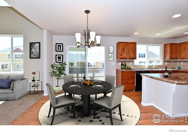 dining room with recessed lighting, a notable chandelier, and light wood-style flooring