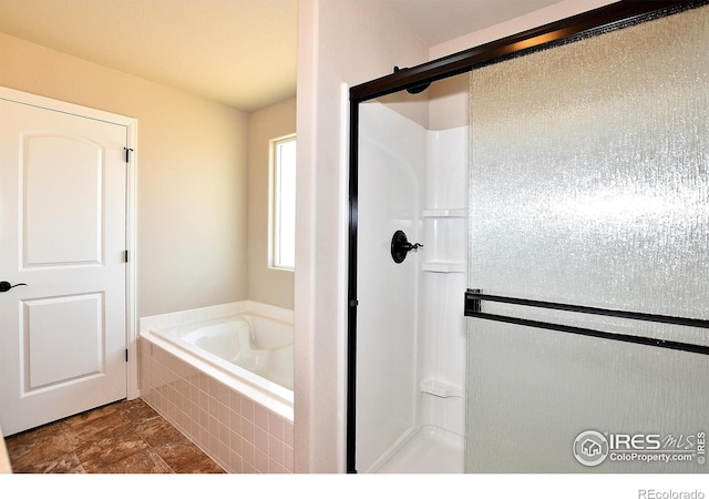 full bath featuring a garden tub and a stall shower