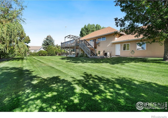 view of yard with stairs and a wooden deck