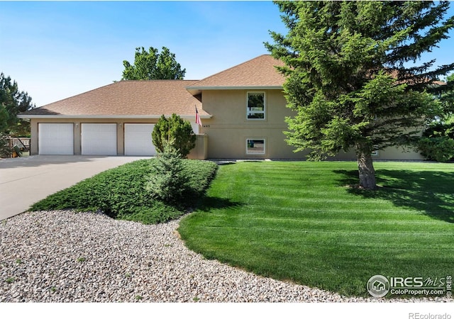 view of front of home featuring an attached garage, a shingled roof, stucco siding, a front lawn, and concrete driveway