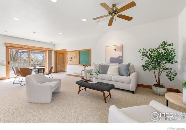 living room with baseboards, recessed lighting, visible vents, and light carpet