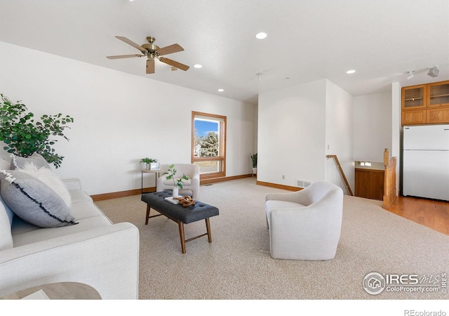 living room with visible vents, baseboards, light colored carpet, recessed lighting, and a ceiling fan