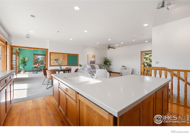 kitchen with ceiling fan, open floor plan, an island with sink, recessed lighting, and a sink