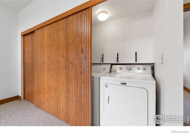 laundry area with washing machine and clothes dryer, laundry area, baseboards, and carpet floors