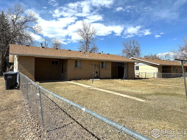 back of house with brick siding and fence