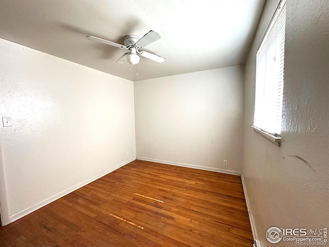 unfurnished room with ceiling fan, baseboards, and wood finished floors