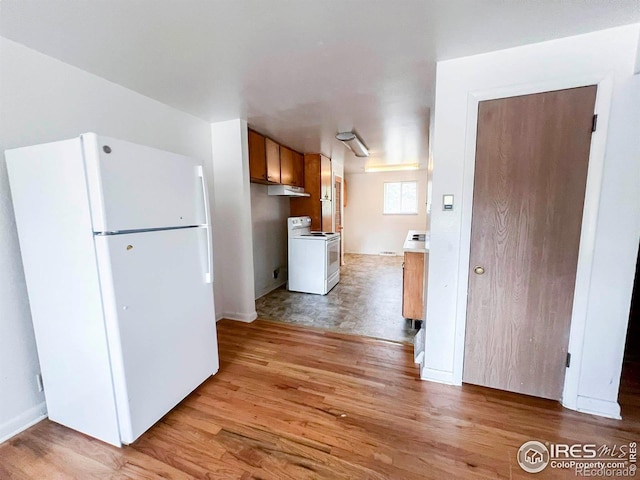 kitchen with white appliances and light wood-type flooring