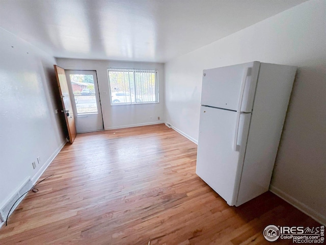 interior space with light wood-style flooring and baseboards