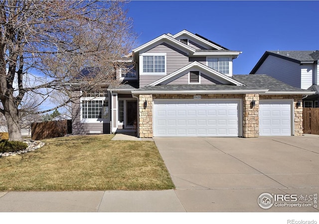 view of front of home with a front yard, fence, driveway, roof with shingles, and stone siding