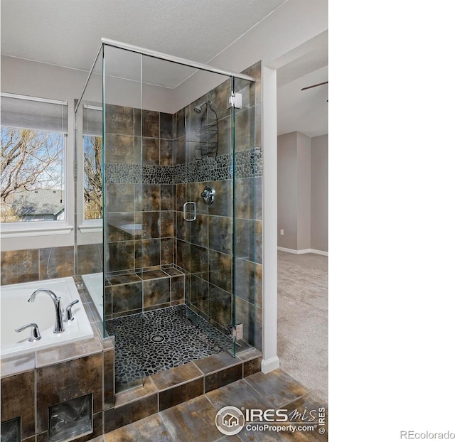 bathroom featuring a shower stall and a garden tub