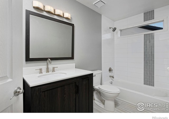 bathroom with vanity, toilet, tub / shower combination, and visible vents