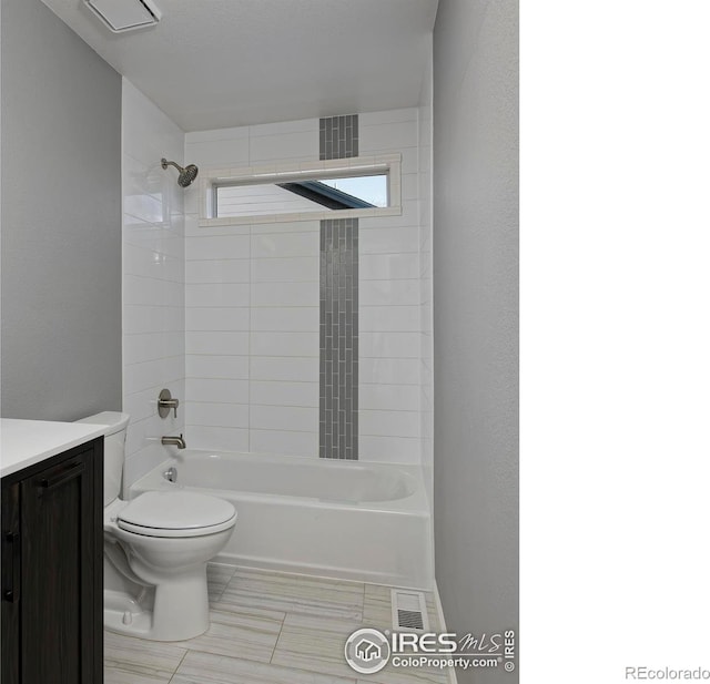 bathroom with visible vents, toilet, shower / washtub combination, and vanity