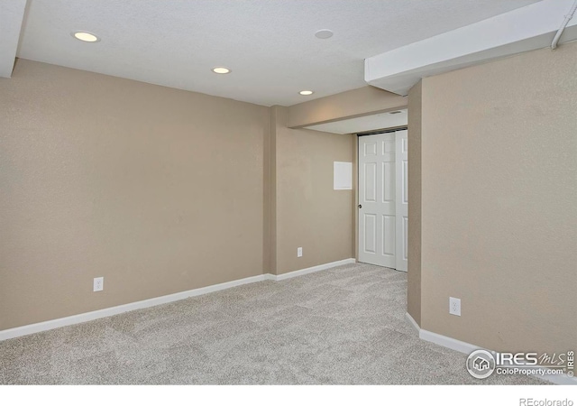 carpeted empty room featuring recessed lighting and baseboards