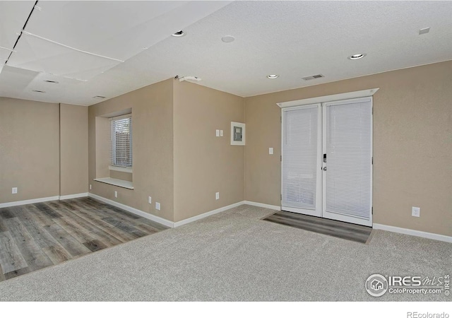 carpeted empty room with visible vents, recessed lighting, and baseboards