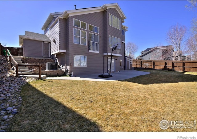 rear view of property with a patio area, a yard, cooling unit, and a fenced backyard