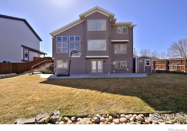 rear view of property featuring a yard, a fenced backyard, an outdoor structure, a storage shed, and a patio area