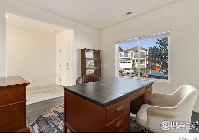 home office featuring visible vents and dark wood finished floors