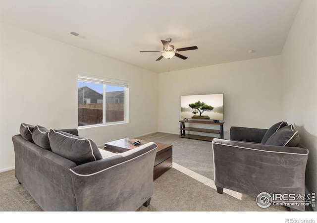 living area with visible vents, ceiling fan, baseboards, and carpet