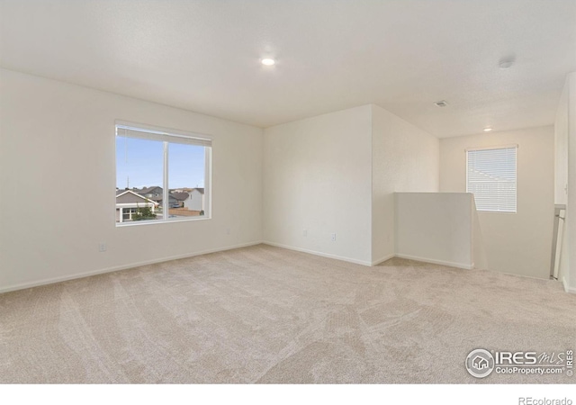 carpeted spare room with recessed lighting and baseboards