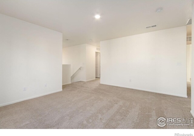 unfurnished room with recessed lighting, visible vents, carpet flooring, and baseboards