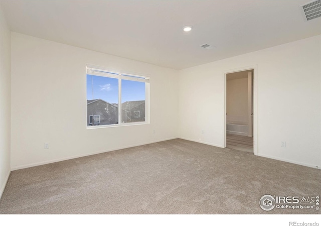 carpeted empty room with visible vents, recessed lighting, and baseboards