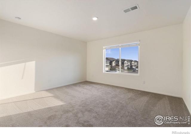 unfurnished room featuring recessed lighting, baseboards, visible vents, and carpet floors