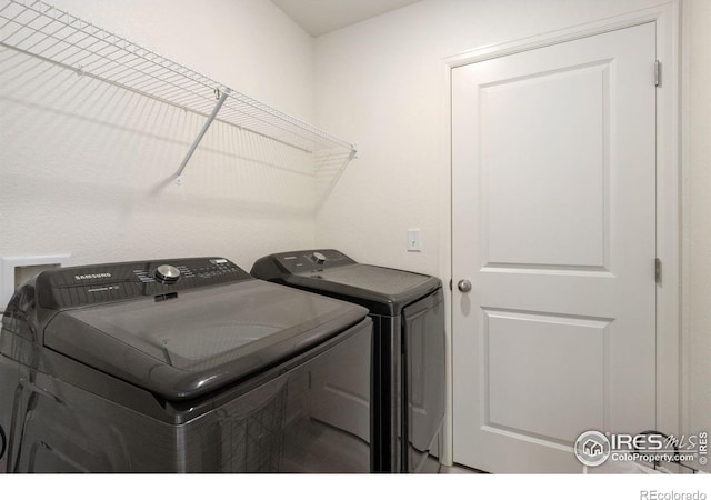 washroom featuring laundry area and washing machine and clothes dryer