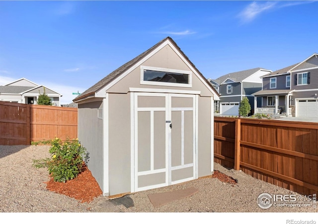 view of shed with a residential view and fence