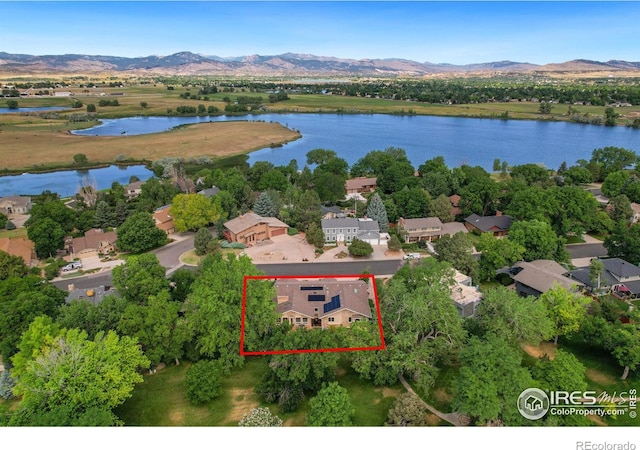 birds eye view of property featuring a water and mountain view