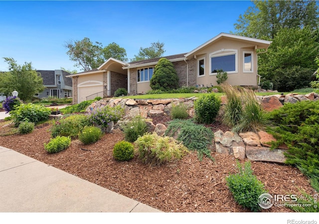 single story home featuring stucco siding and a garage