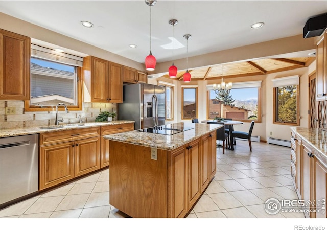 kitchen featuring light tile patterned flooring, appliances with stainless steel finishes, a baseboard heating unit, and a sink