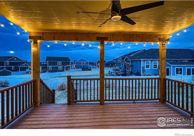 dock area featuring a wooden deck, a residential view, and fence