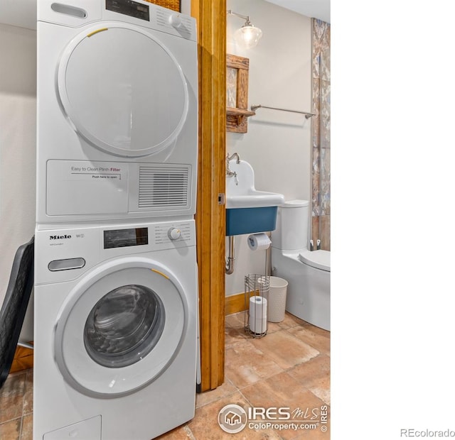 726 Alpine Dr, Estes Park, CO 80517 - laundry room featuring stacked washer / dryer and stone finish floors