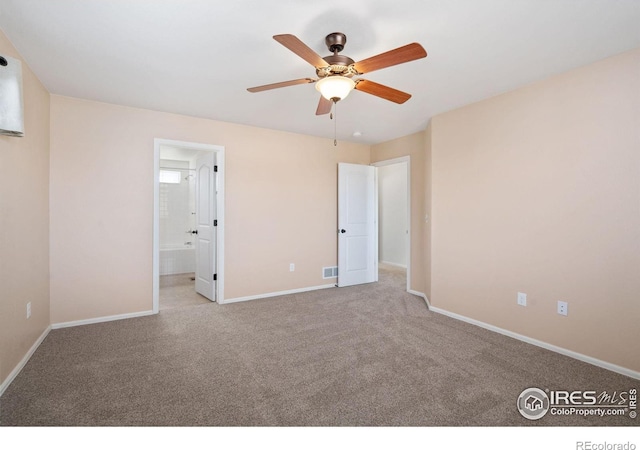 unfurnished bedroom featuring baseboards, a ceiling fan, ensuite bathroom, and carpet flooring