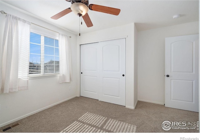 unfurnished bedroom with visible vents, baseboards, carpet, and a closet