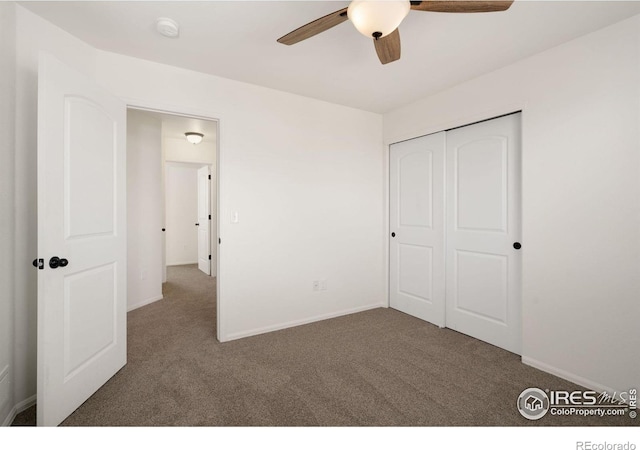 unfurnished bedroom with a closet, baseboards, and carpet floors