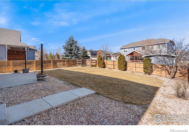 view of yard featuring a patio area and a fenced backyard