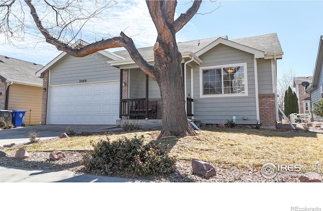 single story home with concrete driveway, an attached garage, and brick siding