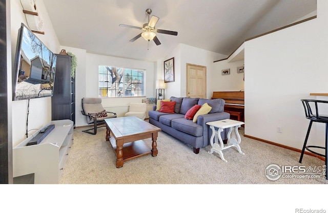 living room with a ceiling fan, vaulted ceiling, carpet, and baseboards