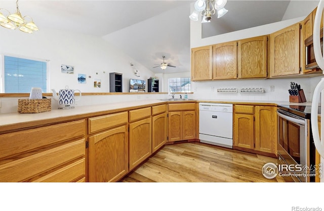 kitchen featuring stainless steel range with electric stovetop, ceiling fan with notable chandelier, a sink, dishwasher, and vaulted ceiling