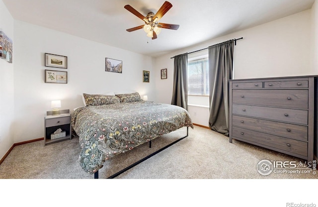 bedroom with ceiling fan, baseboards, and carpet floors