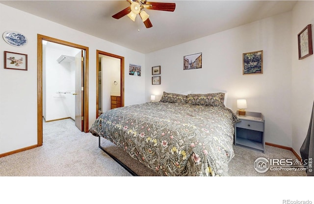 carpeted bedroom featuring ensuite bath, a ceiling fan, and baseboards