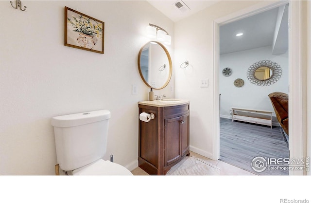 bathroom featuring visible vents, toilet, recessed lighting, baseboards, and vanity