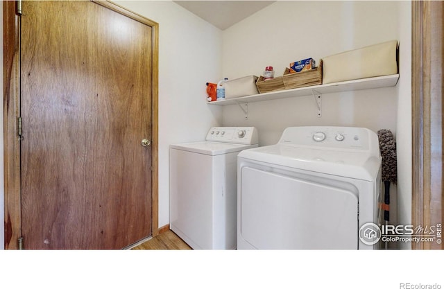 washroom featuring independent washer and dryer, laundry area, and light wood finished floors