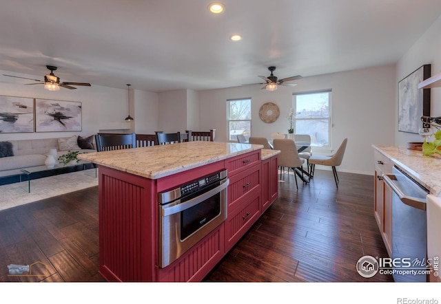 kitchen featuring ceiling fan, open floor plan, recessed lighting, dark wood-style floors, and stainless steel appliances