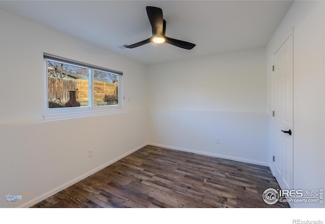 unfurnished bedroom with dark wood finished floors, a ceiling fan, and baseboards