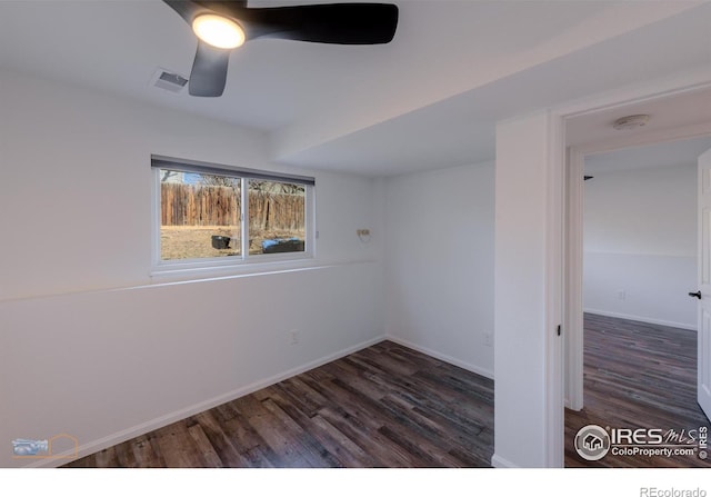 empty room featuring baseboards, wood finished floors, visible vents, and ceiling fan